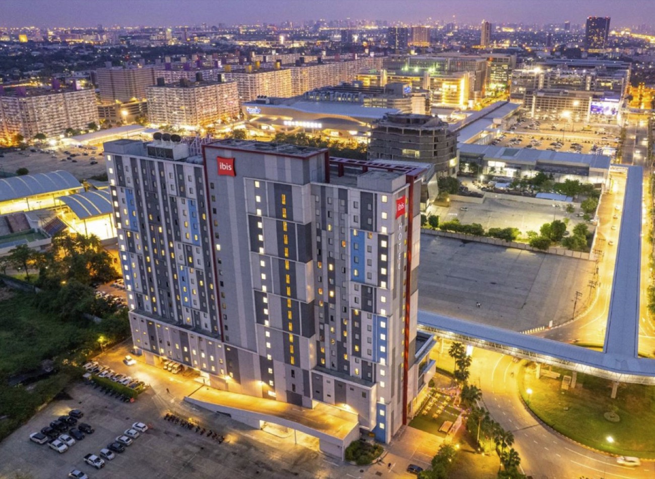 Aerial view of ibis Bangkok IMPACT at dusk within the Muang Thong Thani complex